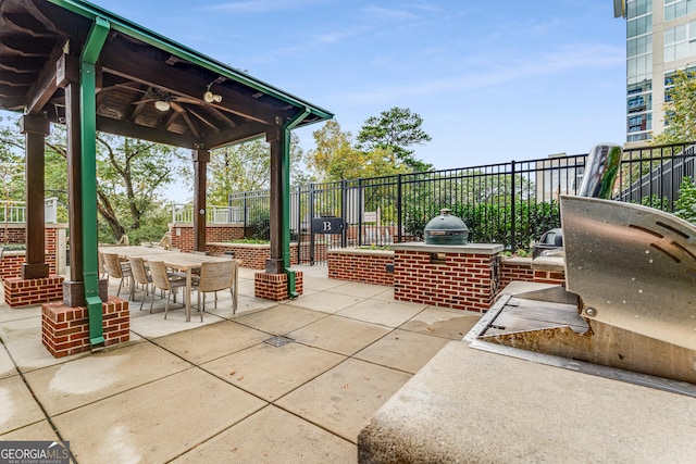 view of patio / terrace with ceiling fan and exterior kitchen