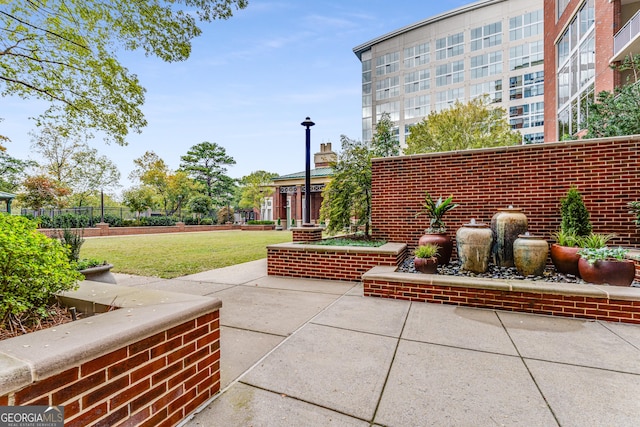 surrounding community with a yard and a patio