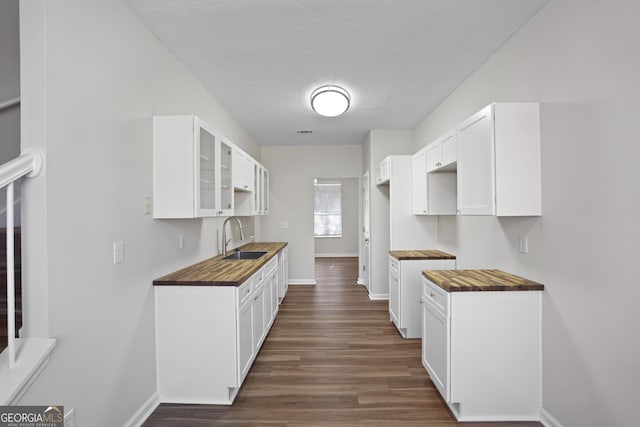 kitchen featuring sink, white cabinets, and dark hardwood / wood-style floors