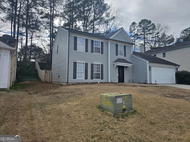 view of front of house featuring a garage and a front lawn