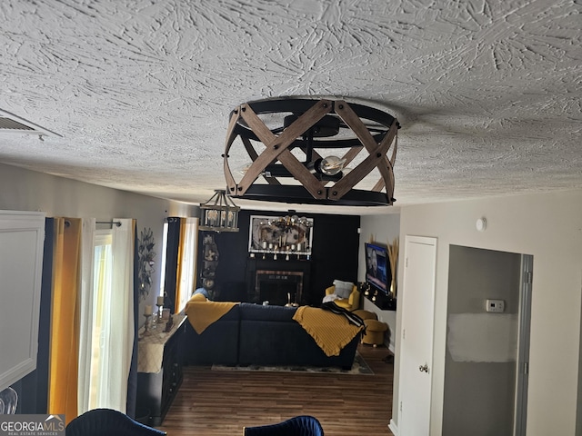 living room with lofted ceiling, dark hardwood / wood-style floors, and a textured ceiling