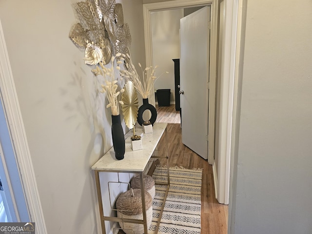 hallway with hardwood / wood-style floors