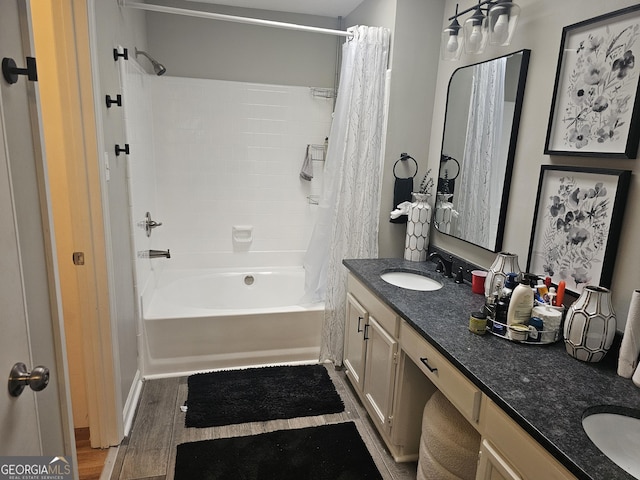 bathroom with shower / bathtub combination with curtain, hardwood / wood-style floors, and vanity