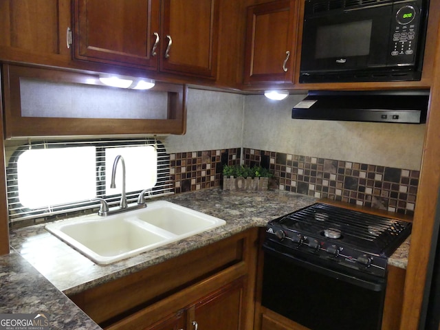 kitchen featuring tasteful backsplash, sink, and black appliances