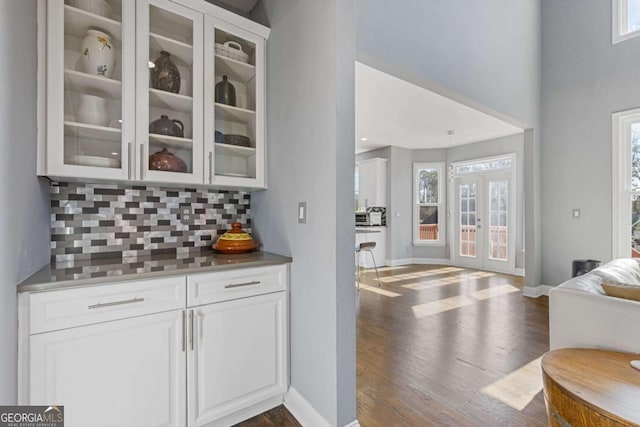 1331 Dayspring Trce, Lawrenceville, GA 30045 - bar featuring tasteful backsplash, white cabinetry, and dark wood-type flooring