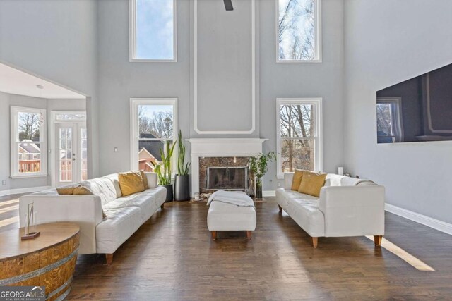 1331 Dayspring Trce, Lawrenceville, GA 30045 - living room with a towering ceiling, a high end fireplace, and dark hardwood / wood-style floors