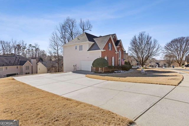 view of property exterior with a yard and a garage