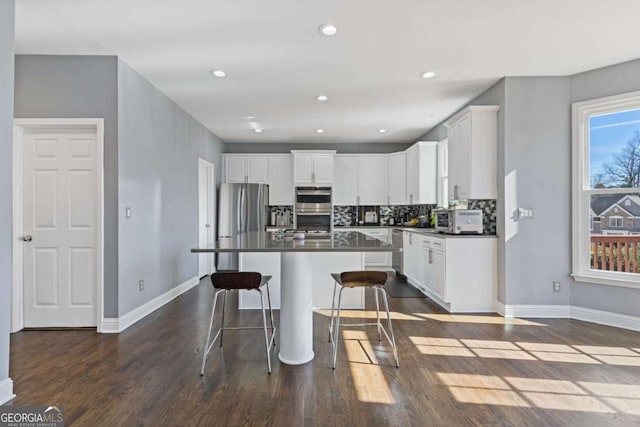 1331 Dayspring Trce, Lawrenceville, GA 30045 - kitchen featuring stainless steel appliances, a kitchen island, white cabinets, and backsplash