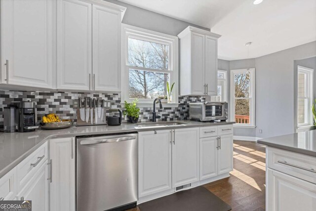 1331 Dayspring Trce, Lawrenceville, GA 30045 - kitchen with dishwasher, sink, and white cabinets