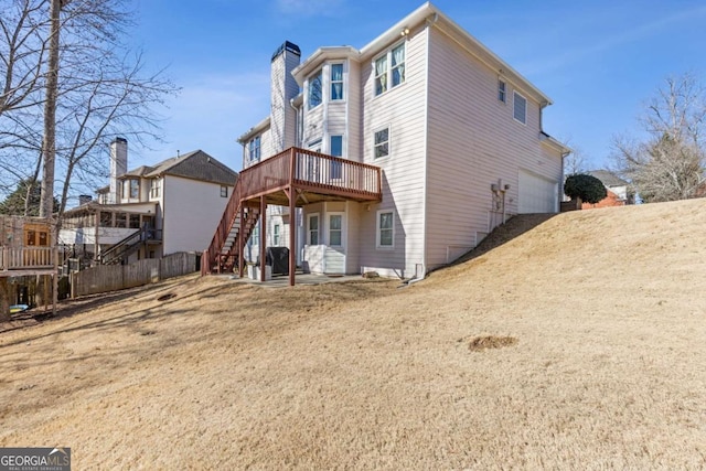 1331 Dayspring Trce, Lawrenceville, GA 30045 - rear view of house featuring a garage and a wooden deck