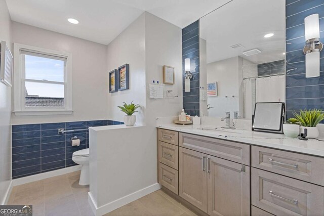 1331 Dayspring Trce, Lawrenceville, GA 30045 - bathroom featuring tile patterned flooring, tile walls, a shower with shower curtain, vanity, and toilet