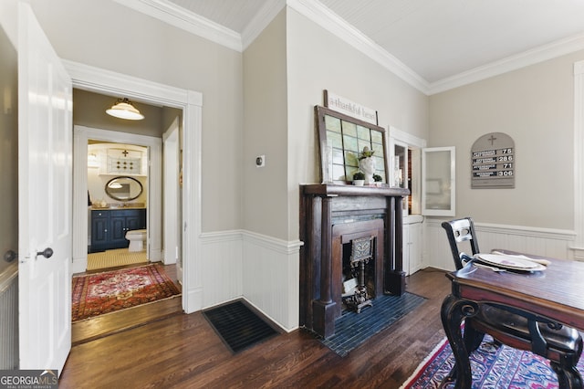 office space with dark wood-type flooring, a wainscoted wall, and a fireplace with flush hearth