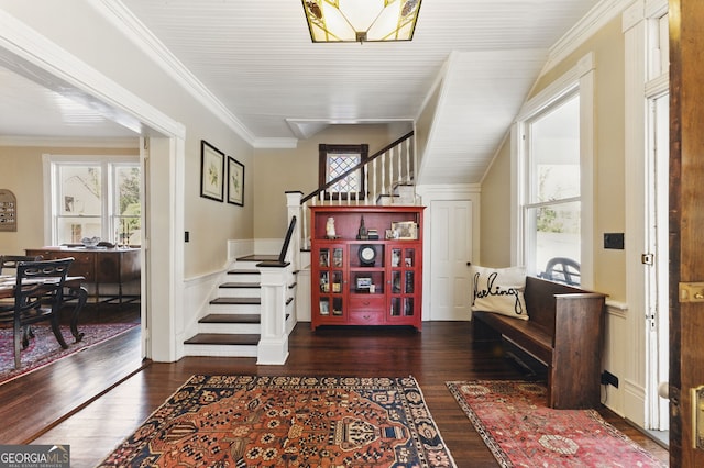 foyer entrance featuring stairs, a wainscoted wall, plenty of natural light, and wood finished floors