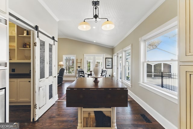 office space featuring dark wood-style floors, visible vents, a barn door, vaulted ceiling, and baseboards