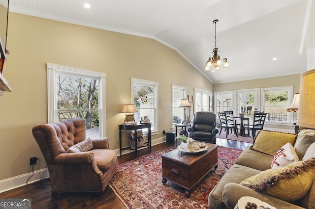 living area featuring lofted ceiling, an inviting chandelier, baseboards, and wood finished floors