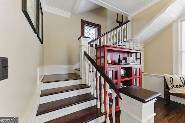 stairs featuring ornamental molding, wood finished floors, and wainscoting