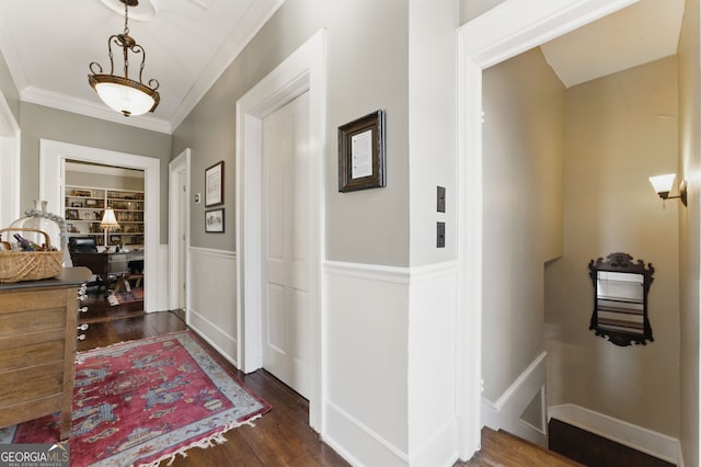 hall featuring dark wood-style floors, ornamental molding, and baseboards