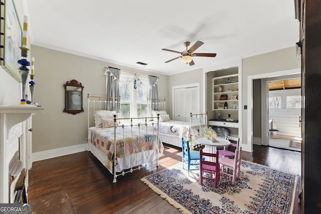 bedroom featuring ornamental molding, baseboards, visible vents, and hardwood / wood-style floors