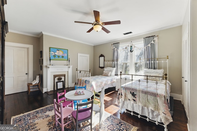 bedroom with crown molding, visible vents, and hardwood / wood-style floors