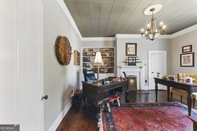 office area with baseboards, wood finished floors, an inviting chandelier, crown molding, and a fireplace