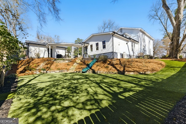 exterior space featuring an attached carport and a yard