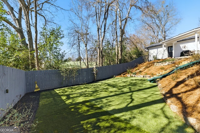 view of yard with a fenced backyard