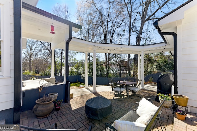 view of patio / terrace with outdoor dining space, fence, and area for grilling