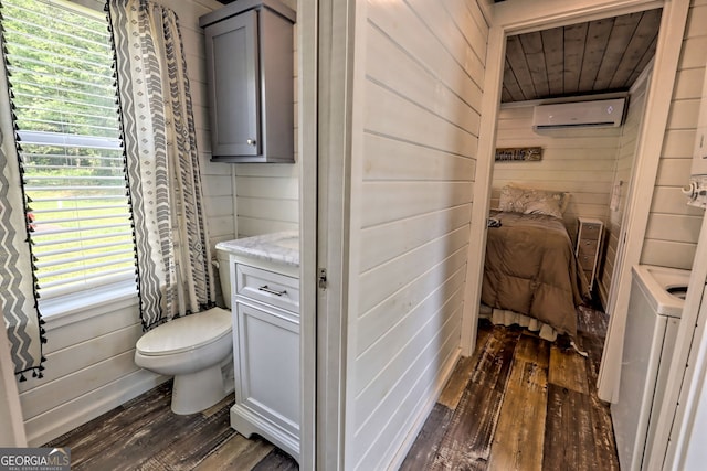 bathroom with a wall mounted air conditioner, hardwood / wood-style flooring, and wooden walls