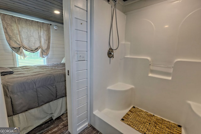 bathroom featuring wood-type flooring and a shower