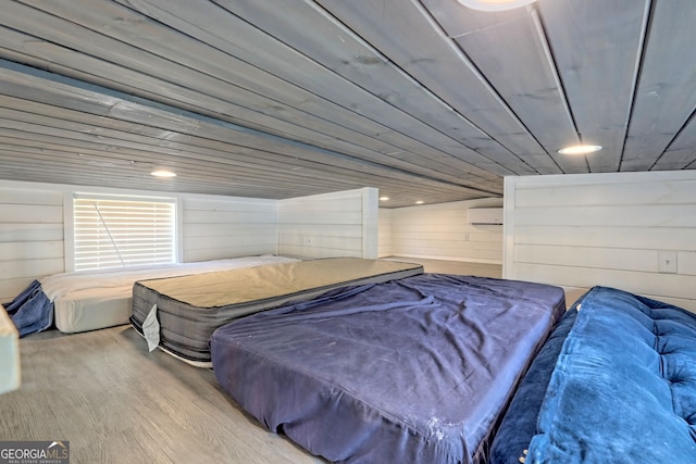 bedroom with wood ceiling, wooden walls, and hardwood / wood-style flooring