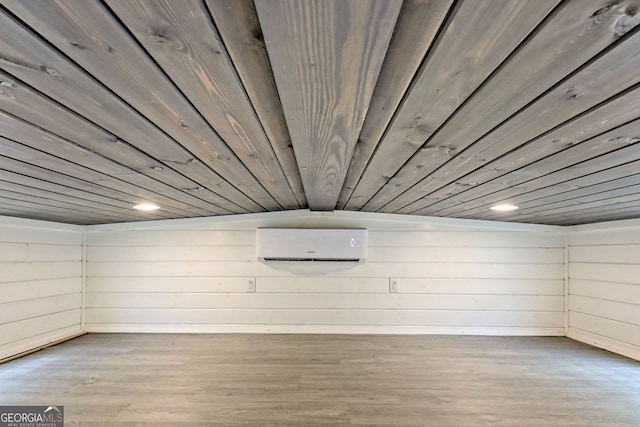 basement featuring hardwood / wood-style floors, a wall mounted AC, and wooden ceiling