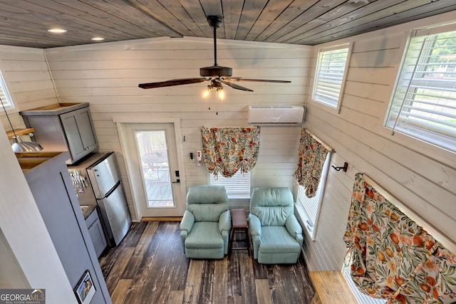 living area featuring wood ceiling, a healthy amount of sunlight, dark hardwood / wood-style floors, and a wall mounted AC