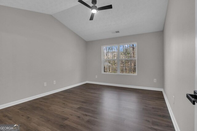 spare room with dark hardwood / wood-style flooring and a chandelier