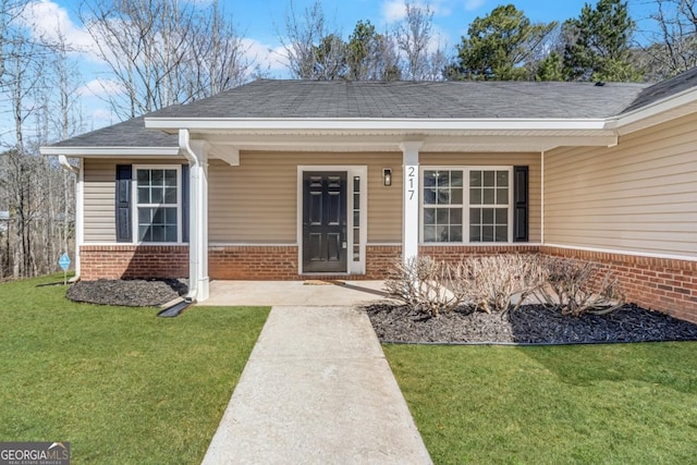 property entrance with a yard