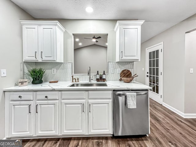 kitchen featuring sink, tasteful backsplash, dark hardwood / wood-style floors, dishwasher, and white cabinets