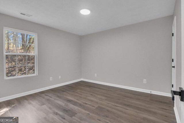 laundry room featuring dark wood-type flooring and plenty of natural light