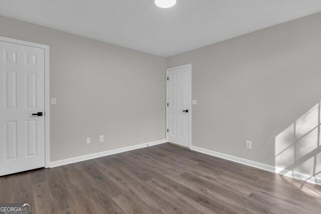 empty room featuring dark hardwood / wood-style flooring