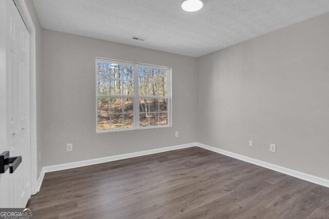 full bathroom featuring hardwood / wood-style flooring, vanity, toilet, and  shower combination