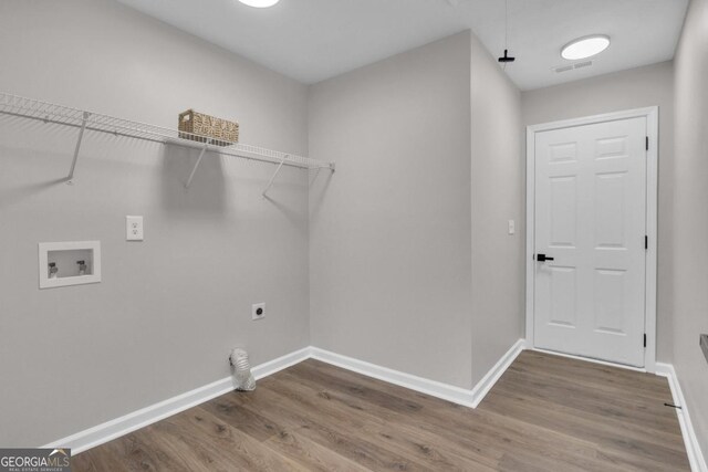 washroom featuring dark wood-type flooring, washer hookup, and hookup for an electric dryer