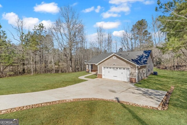 ranch-style house featuring a garage and a front lawn