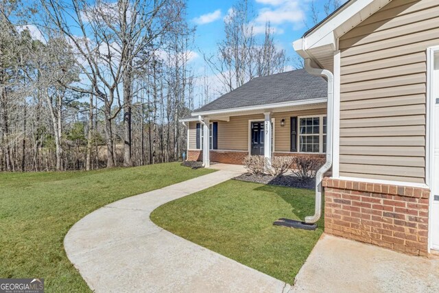 view of home's exterior with a garage and a lawn