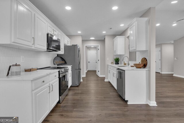 kitchen featuring light stone counters, tasteful backsplash, appliances with stainless steel finishes, dark hardwood / wood-style flooring, and white cabinets