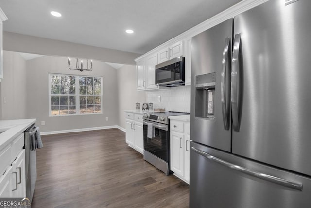 kitchen featuring lofted ceiling, tasteful backsplash, appliances with stainless steel finishes, dark hardwood / wood-style floors, and white cabinets