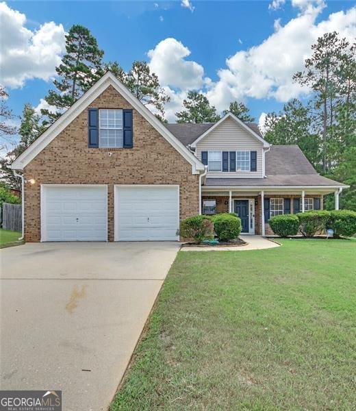 view of front of property with a garage and a front lawn