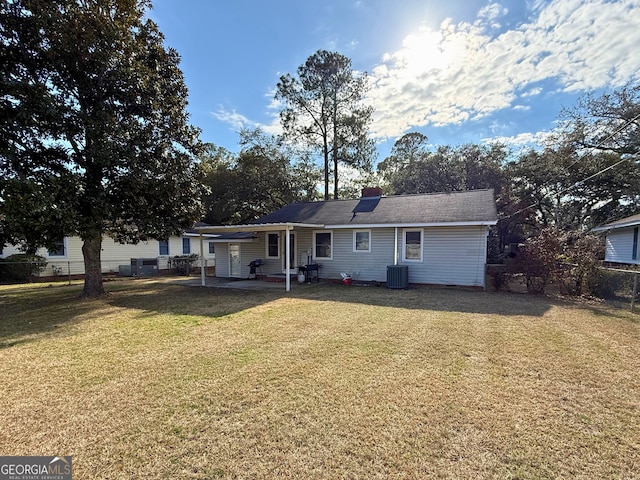 rear view of house with a yard, a patio area, and central air condition unit