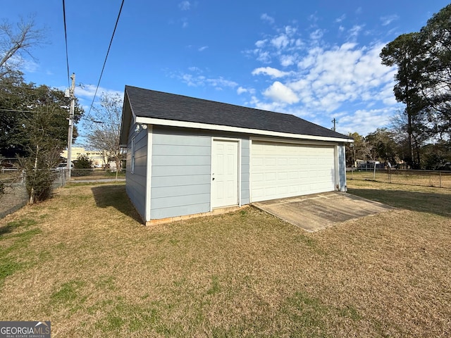 garage featuring a lawn