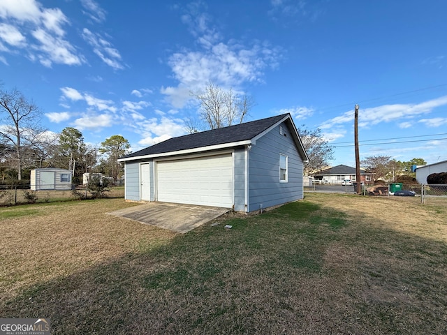 garage featuring a lawn