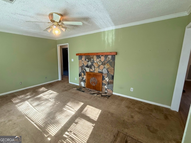 unfurnished living room featuring a stone fireplace, a textured ceiling, ornamental molding, ceiling fan, and carpet