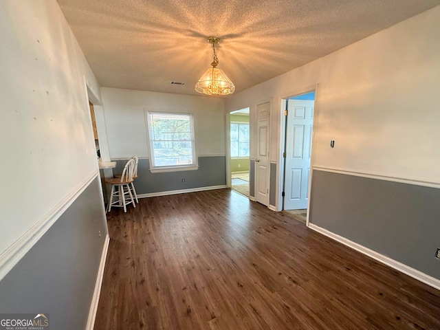 interior space featuring dark hardwood / wood-style flooring and a textured ceiling