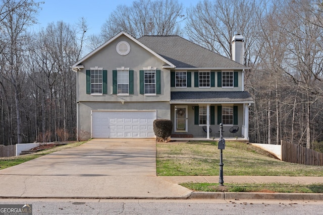 front of property featuring a front lawn and a garage